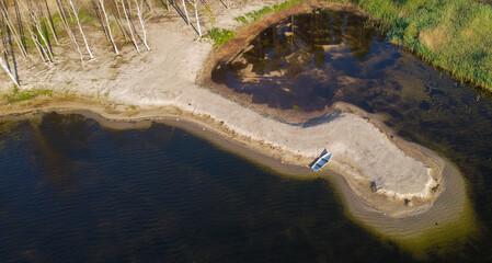 Solitary Boat on a Sandy Lakeside Spit. Daugavpils, Latvia