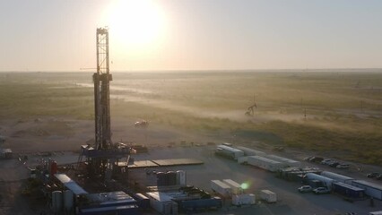 Aerial Drone at Sunrise on a Rural Texas Oil Well and Gas Drill Site - sunset with pump jack