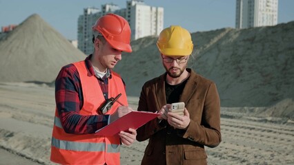 Man writing on documentation, director controlling work process