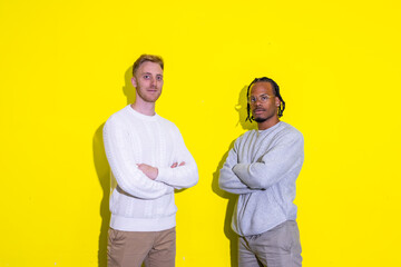 Two businessmen standing in front of a yellow wall