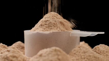 Chocolate color protein, whey powder in cup. Bodybuilding, fitness and gym lifestyle