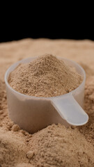 Chocolate colour protein, whey powder sprinkle in cup. Bodybuilding, fitness and gym lifestyle