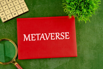 Metaverse concept. Written metaverse single word on the cover of a business notebook on a beautiful green background with a calculator, magnifying glass and a plant