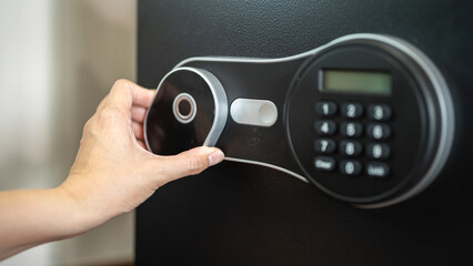 Action of people hand is unlocking to open the safe box door by scanning fingerprint on the on the...