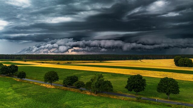 Dramatic view of an incoming storm over a vast expanse of plains, with dark clouds rolling