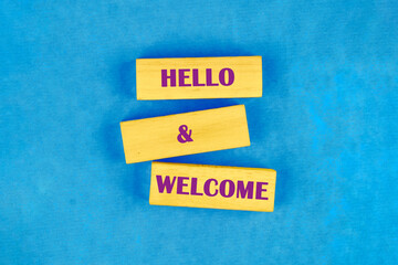 Communication concept, introduction. Words HELLO and WELCOME on blocks made of wood, top view...