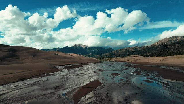 Drone shot over Great Sand Dunes National Park and Preserve under a blue sky