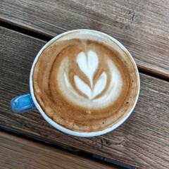 Top view of a cup of coffee on a wooden table
