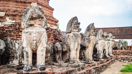 Ancient lion statues located around an old Ayutthaya period pagoda at Wat Thammikarat, Phra Nakhon...