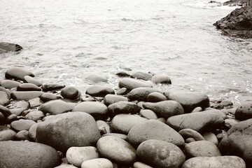 Expansive stretch of rocky beach washed by the lapping waves of the sea