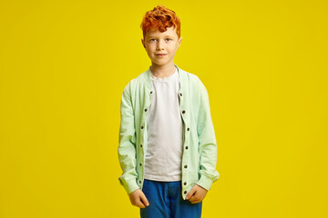 Waist Portrait of Handsome Red Haired Child Boy Around 6-7 years Wearing in Turquoise Shirt, White...