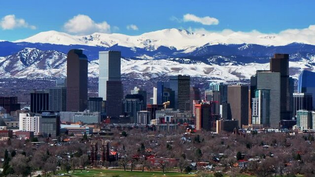 Spring Downtown Denver Colorado City Park Mount Blue Sky Evans Aerial drone USA Front Range Rocky Mountains toothills skyscrapers landscape Ferril Lake daytime sunny clouds neighborhood upward jib