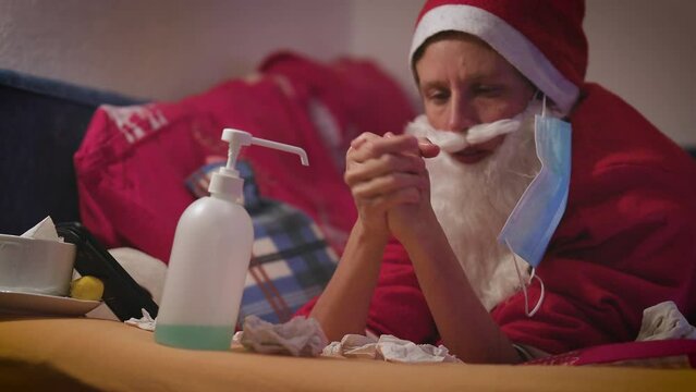 Woman Santa in Costume in Bed with Flue - Facial Mask and Disinfection - Quarantine Concept