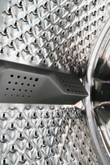 Close-Up of Modern Washing Machine Drum Interior with Stainless Steel Texture for Laundry and Cleaning Concepts