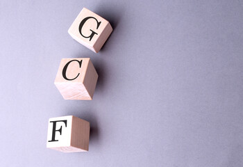 GCF word on wooden block on gray background