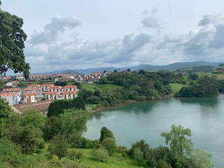 Obraz premium Idyllic landscape of a small village situated atop a lake: Asturias
