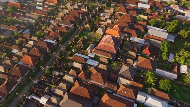 Aerial view of traditional wooden houses in Penglipuran village at sunrise, Bangli District, Bali, Indonesia.