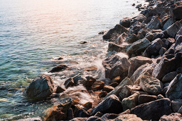 Background of clear waters against a rocky beach