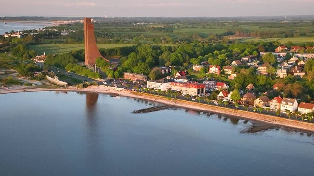 Aerial footage flying over Baltic Sea resort of Laboe, showcasing beach, promenade and  naval memorial, Schleswig-Holstein, Germany.