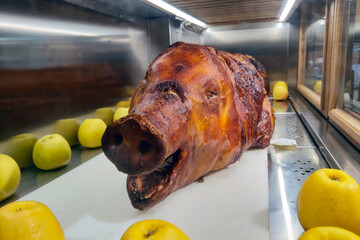 Whole Roasted Pig with Apples in a Display Case for Gourmet Food and Culinary Arts