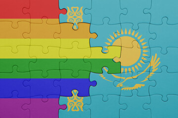 puzzle with the colourful national flag of kazakhstan and rainbow gay pride flag .
