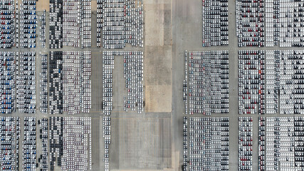 aerial top down view of a parking lot new cars lined up in the port for import and export international.