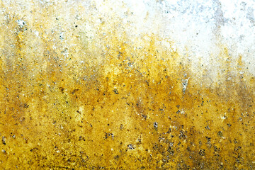 A weathered metal surface covered in rust with patches of yellow and black paint