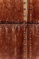 Rusted and riveted industrial metal surface