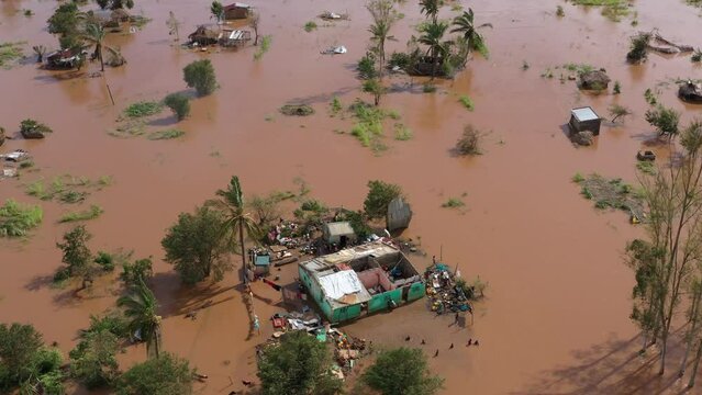 Drone footage over poor African people with damaged houses and trees in the flood in Mozambique