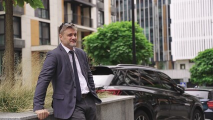Adult man in suit resting outdoors in the city.