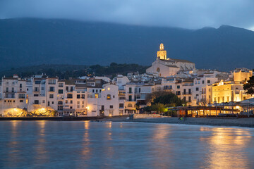 Fototapeta premium With illuminated lights and their reflections on water in Cadaques town in Catalonia