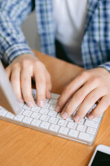 Close-up Businessman working online on the table at home, hands  typing on laptop keyboard, online job concept.