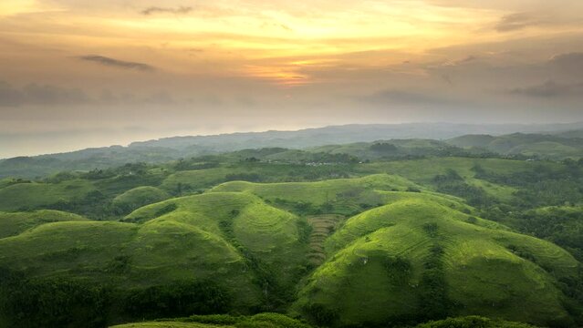Teletubbies Hill at sunset, Nusa Penida, Bali in Indonesia. Aerial drone panoramic view and sky for copy space. Hyperlapse time-lapse