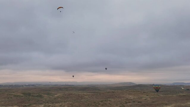 Temecula Balloon and Wine Festival Drone Footage Four Hot Air Balloons With Two Paragliders One Flies Out of Frame