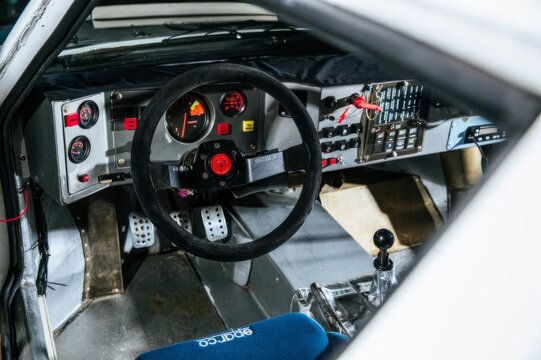 interior of Lancia Delta Abarth S4 rally racing car with steering wheel and instruments