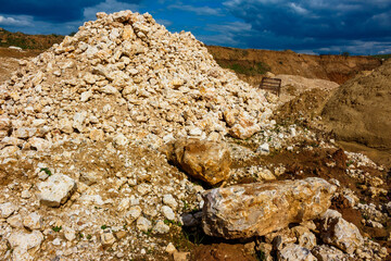 View of a quarry for the extraction of crushed stone, a pile of broken limestone in a quarry