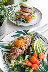 Breakfast plates with croissants with avocado and salad. brunch .