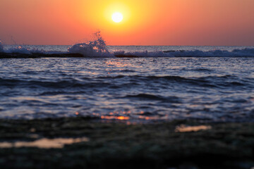 Tranquil seascape at sunset with gentle waves splashing in the distance