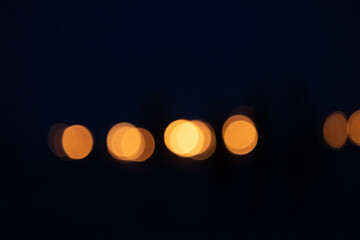 Abstract, blurry bokeh picture of a fire festival at the beach of Baltic Sea. Artistic, colorful scene.
