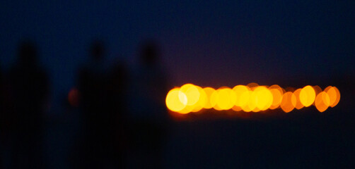 Abstract, blurry bokeh picture of a fire festival at the beach of Baltic Sea. Artistic, colorful...