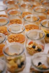 Assorted delectable desserts displayed in glass jars