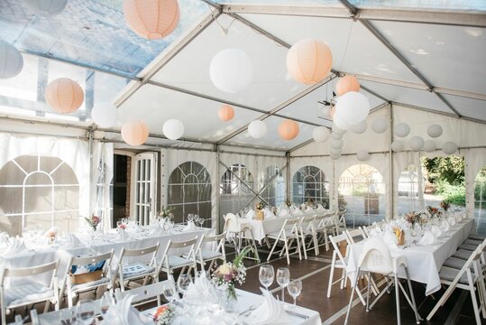 Event setup under large paper lanterns in a tent