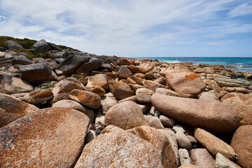 Beautiful beach with rocks on it with the sea in the background in Bay of Fire, Tasmania, Australia