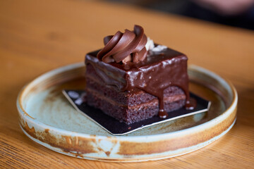 a delicious cake on a plate placed on the table.