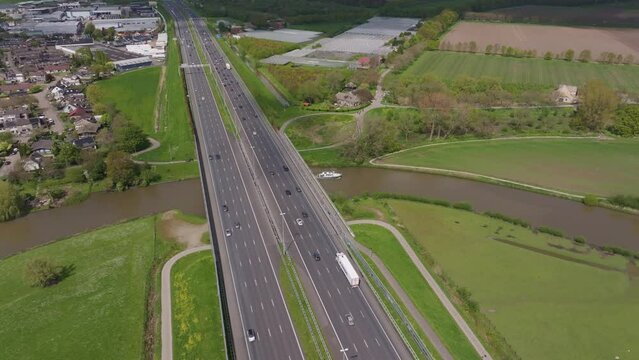 Aerial view of farmland and river with highway, Beesd, Gelderland, Netherlands.
