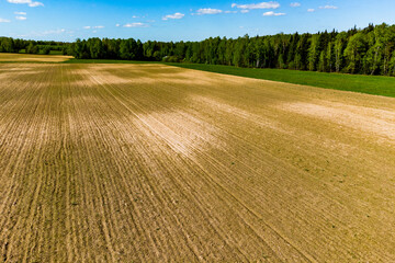 Aerial view of a large plowed farmer's field in the countryside
