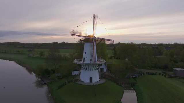Aerial view of historic windmill De Vlinder by river Linge at sunrise, Deil, Gelderland, Netherlands.