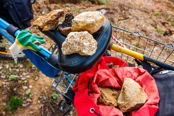 Rockhounding for minerals and fossils with a bicycle, packing collected samples