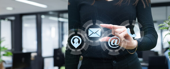 Businesswoman working on virtual computer screen with contact icon .
