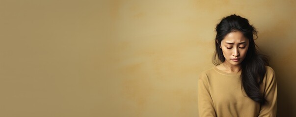 Beige background sad Asian Woman Portrait of young beautiful bad mood expression Woman Isolated on...